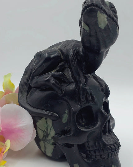 One-of-a-kind Peony Stone velociraptor on human skull carving xl