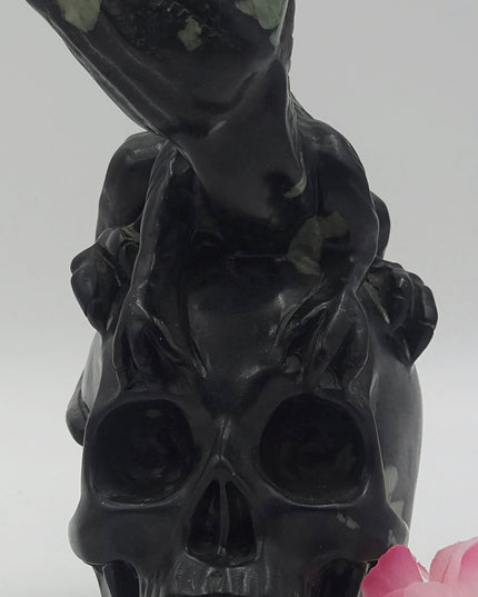One-of-a-kind Peony Stone velociraptor on human skull carving xl