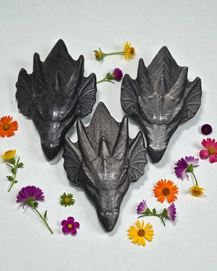 Obsidian dragon head carvings