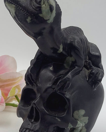 One-of-a-kind Peony Stone velociraptor on human skull carving xl